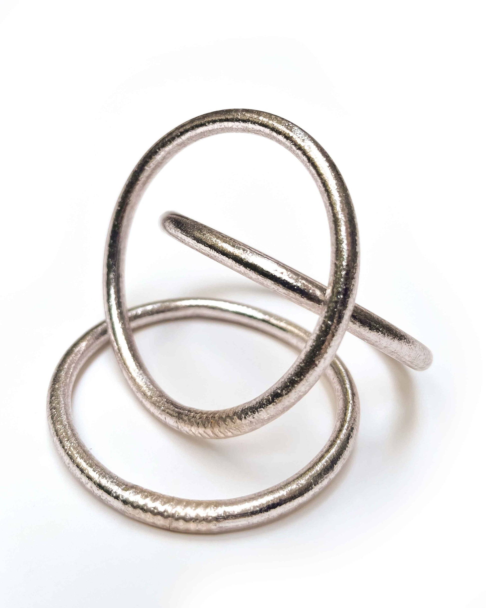 Chunky Kumlai Buddhist bangles in Rose Silver on a white background.