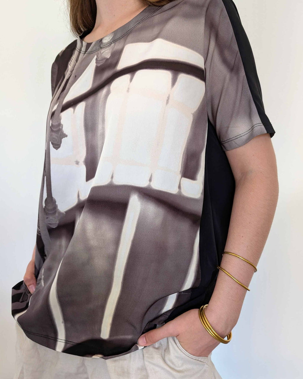 Kumlai Buddhist bangles in classic gold, slim style, worn with a printed top. (1)