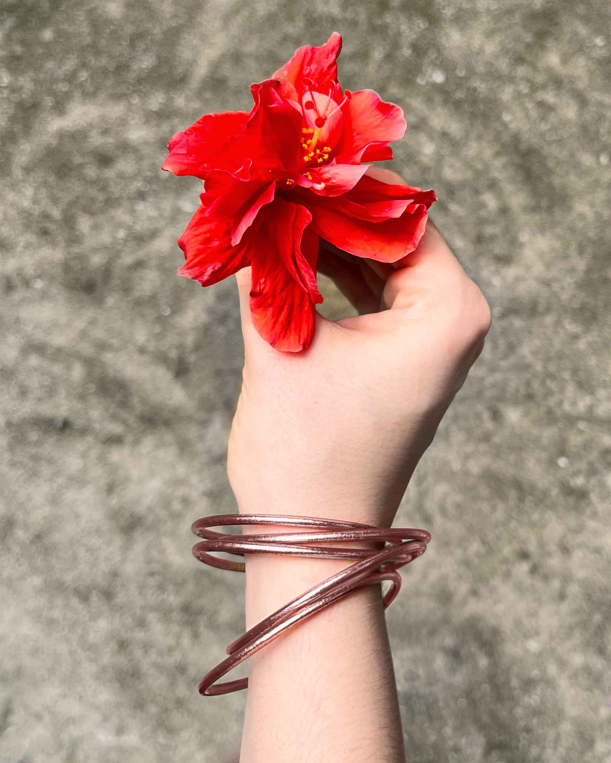 Kumlai Buddhist bangles in rose gold, slim style, with a large red flower.