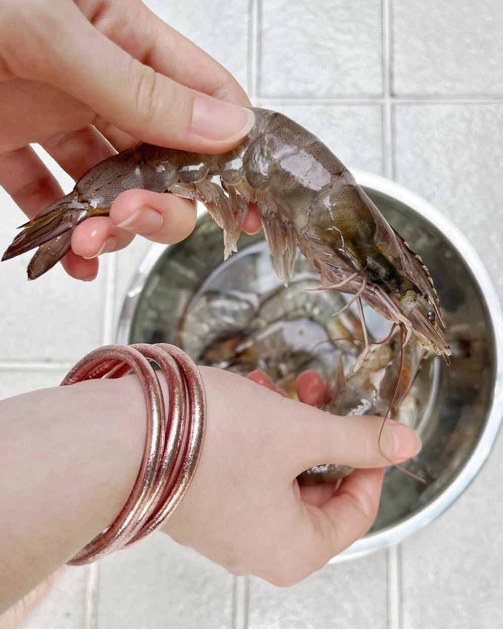 Chunky Kumlai Buddhist bangles in Rose Gold worn in the kitchen.