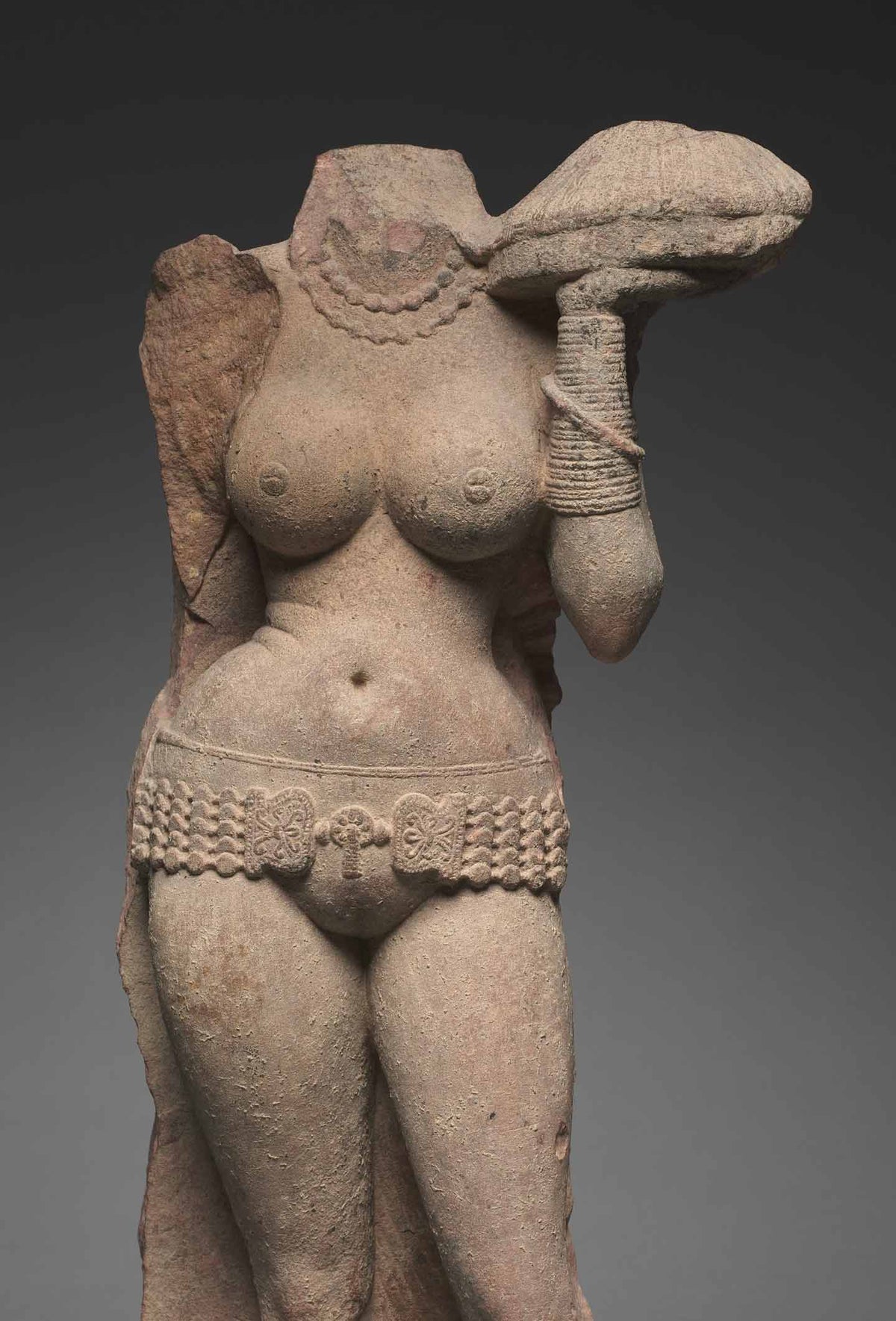 A sculpture of a devotee wearing stacked   bangles, India, Mathura, Kushan period, circa 100 CE.